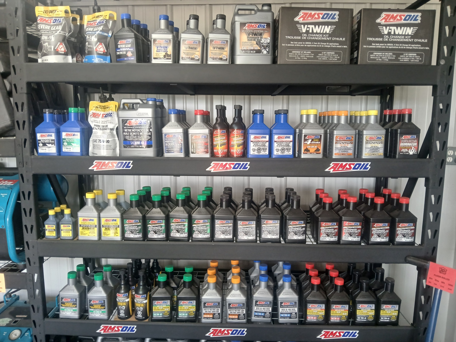 AMSOIL synthetic oil display shelf stocked with motor, gear and diesel oils