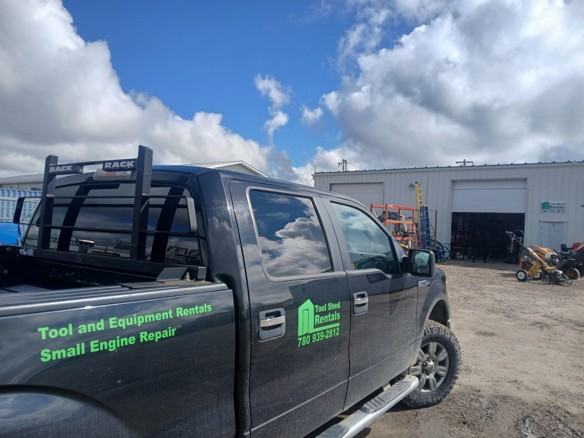 Tool Shed Rentals service truck parked outside the shop bays